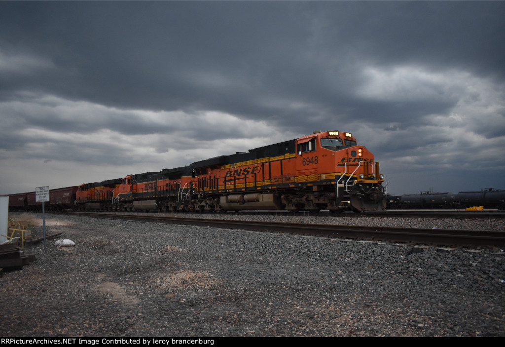 BNSF 6948 brings a eb empty grain train with a bad storm approaching